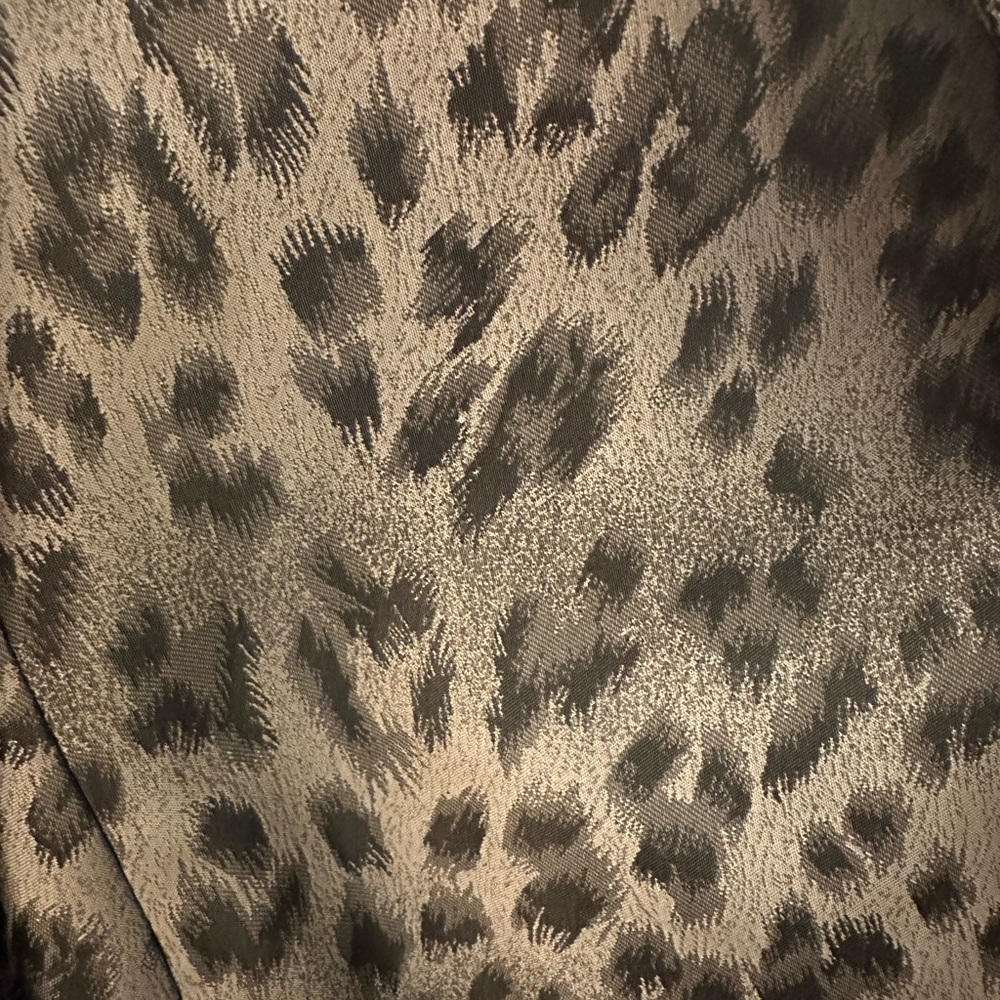 Collections for Le Suits Leopard print jacket with a black skirt.